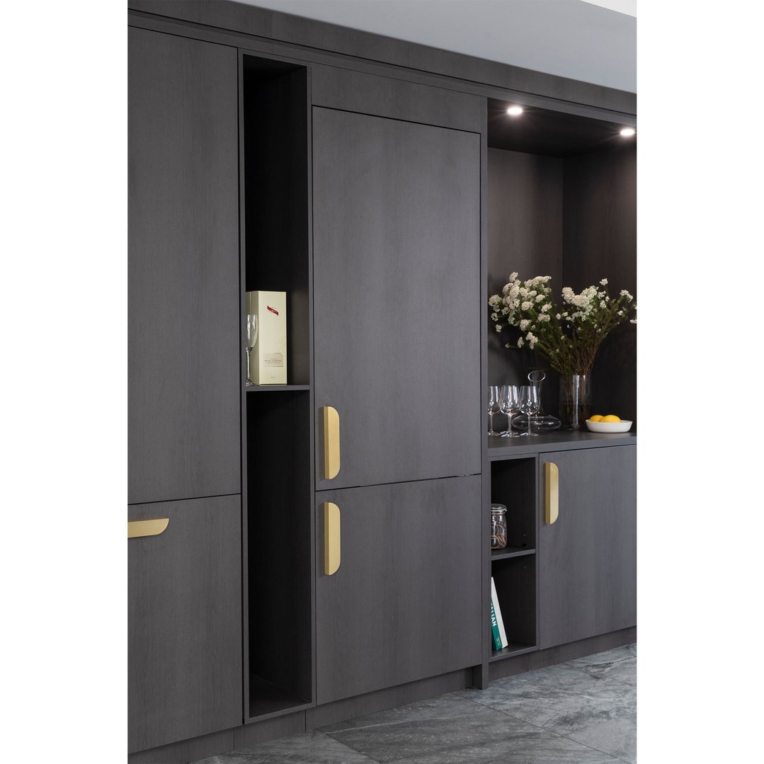 Integrated bottom mount fridge in a dark wood kitchen cabinet setting
