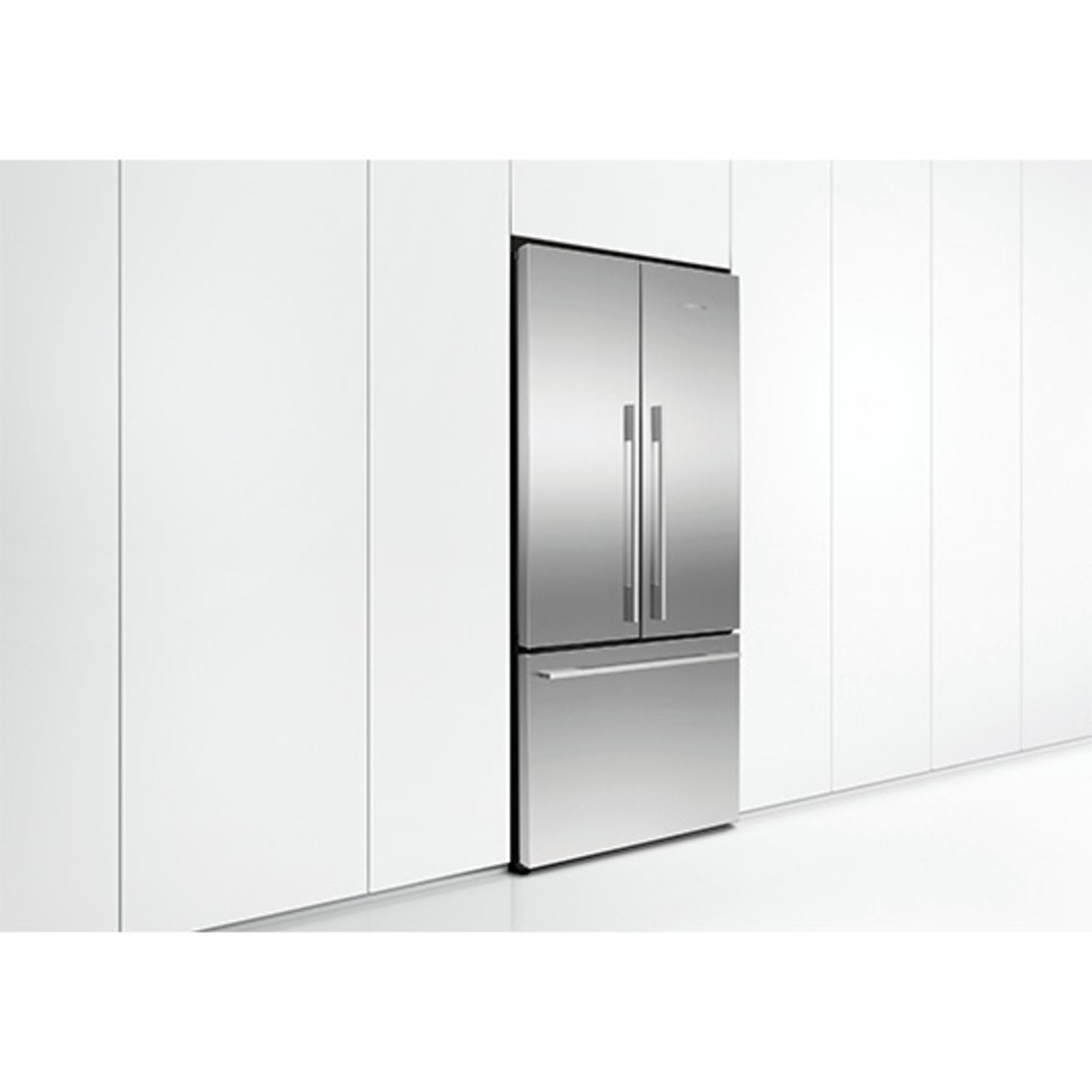 Stainless steel French door refrigerator freezer integrated into white kitchen cabinetry