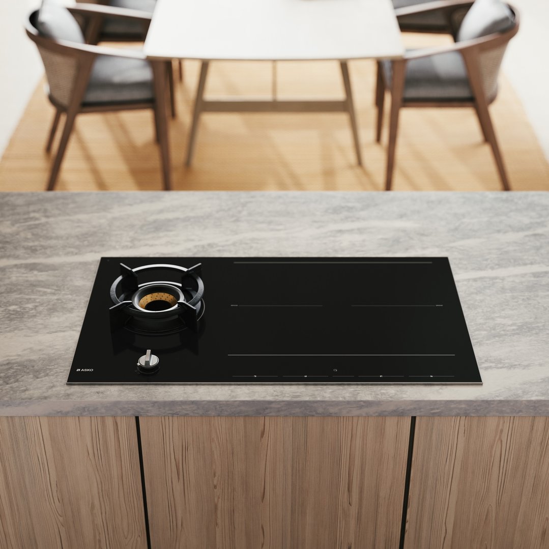 Black cooktop with gas burner and induction zones in a modern kitchen