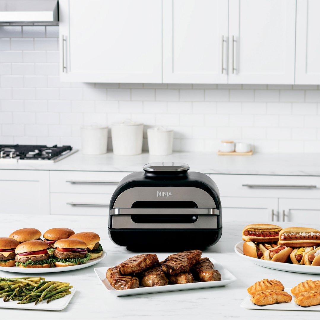 Ninja Foodi Smart XL Grill & Air Fryer on a kitchen counter with food