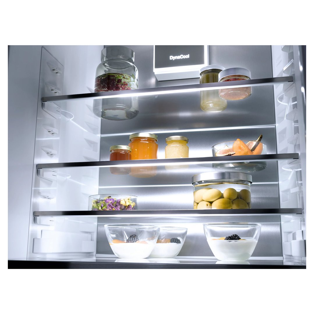 Interior of a fully integrated fridge with various food items on shelves