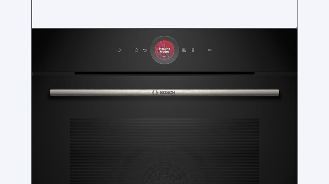 Black built-in oven with a silver handle and a digital display showing heating modes