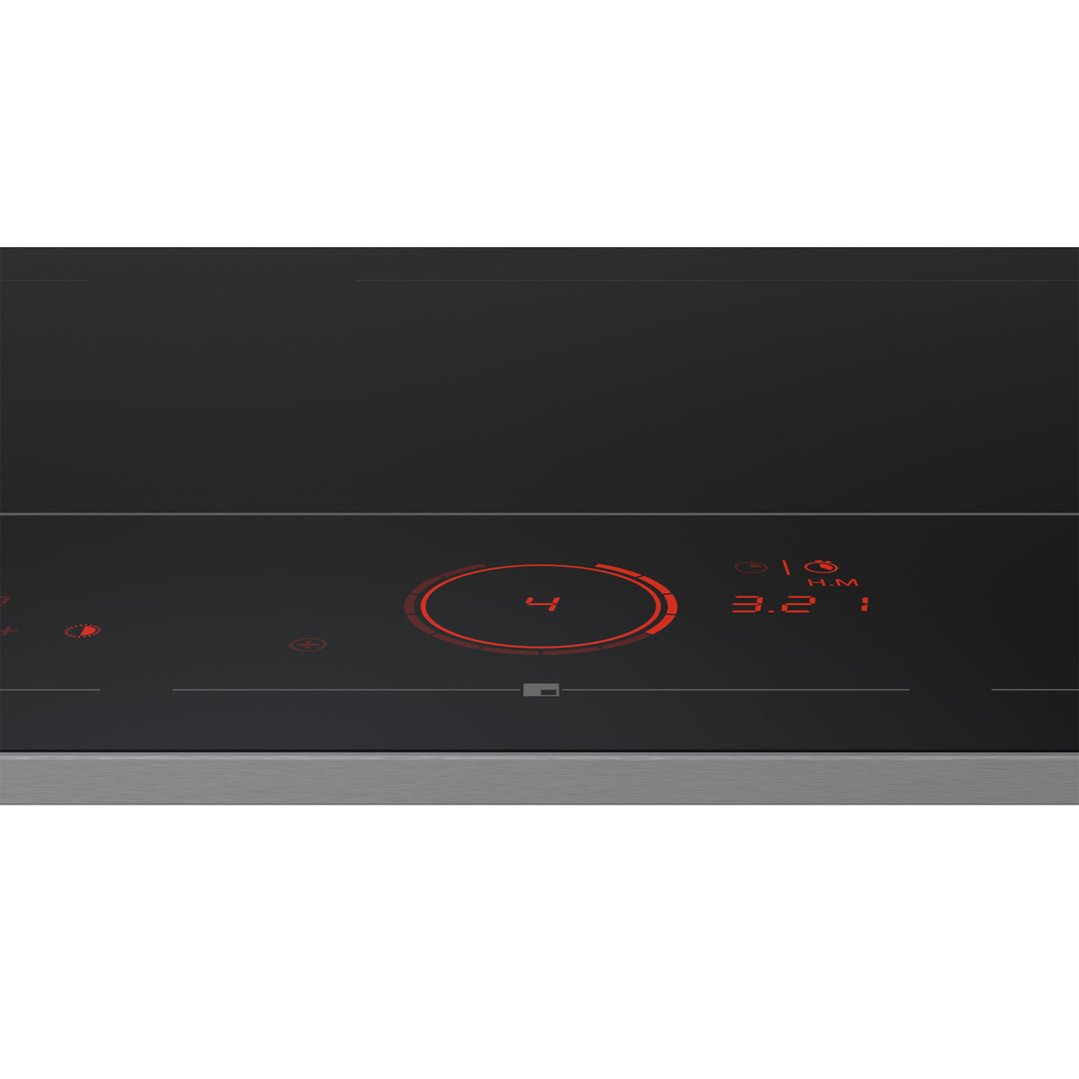 Close-up of a black induction cooktop with red illuminated controls and digital display