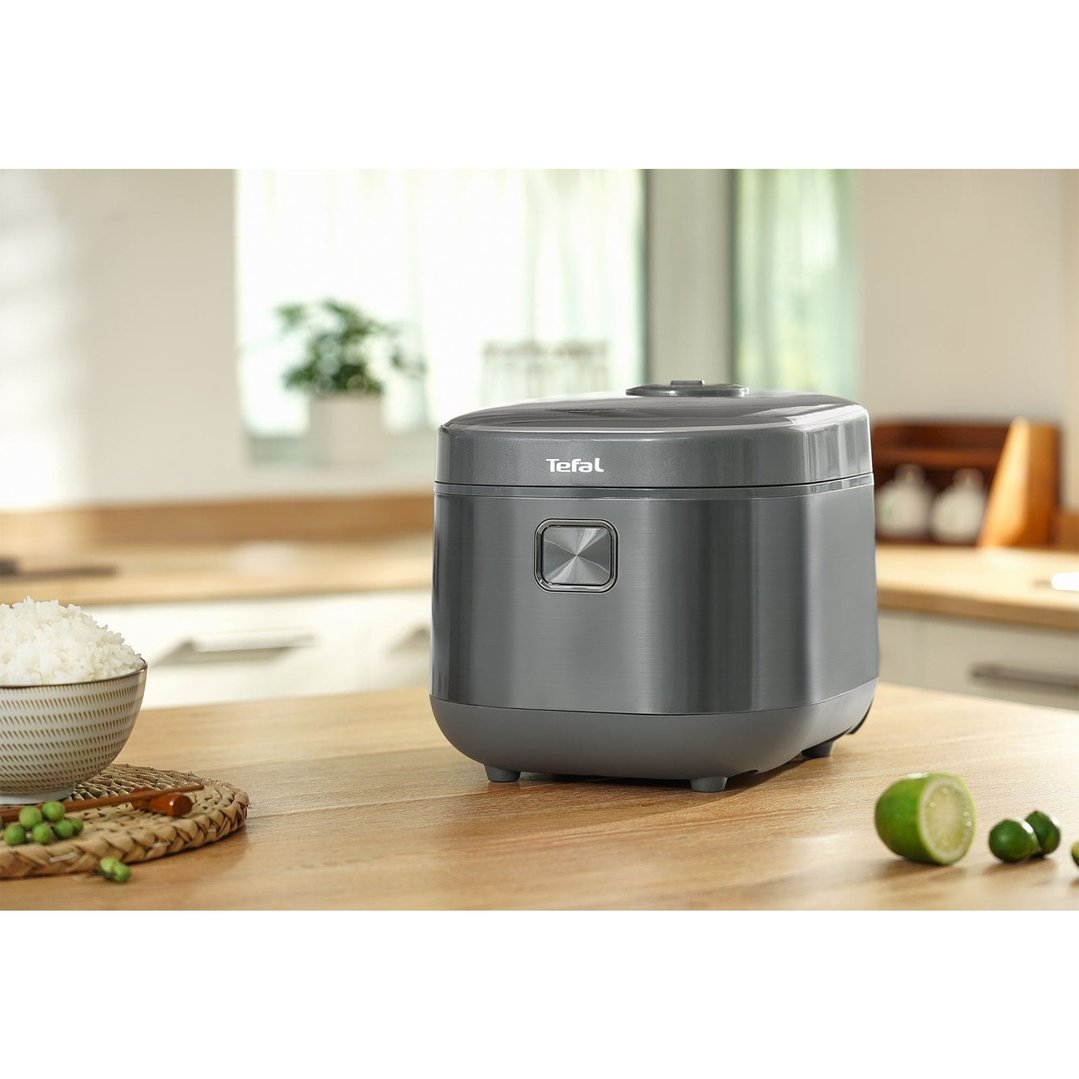 Tefal rice cooker on a wooden kitchen counter with a bowl of rice