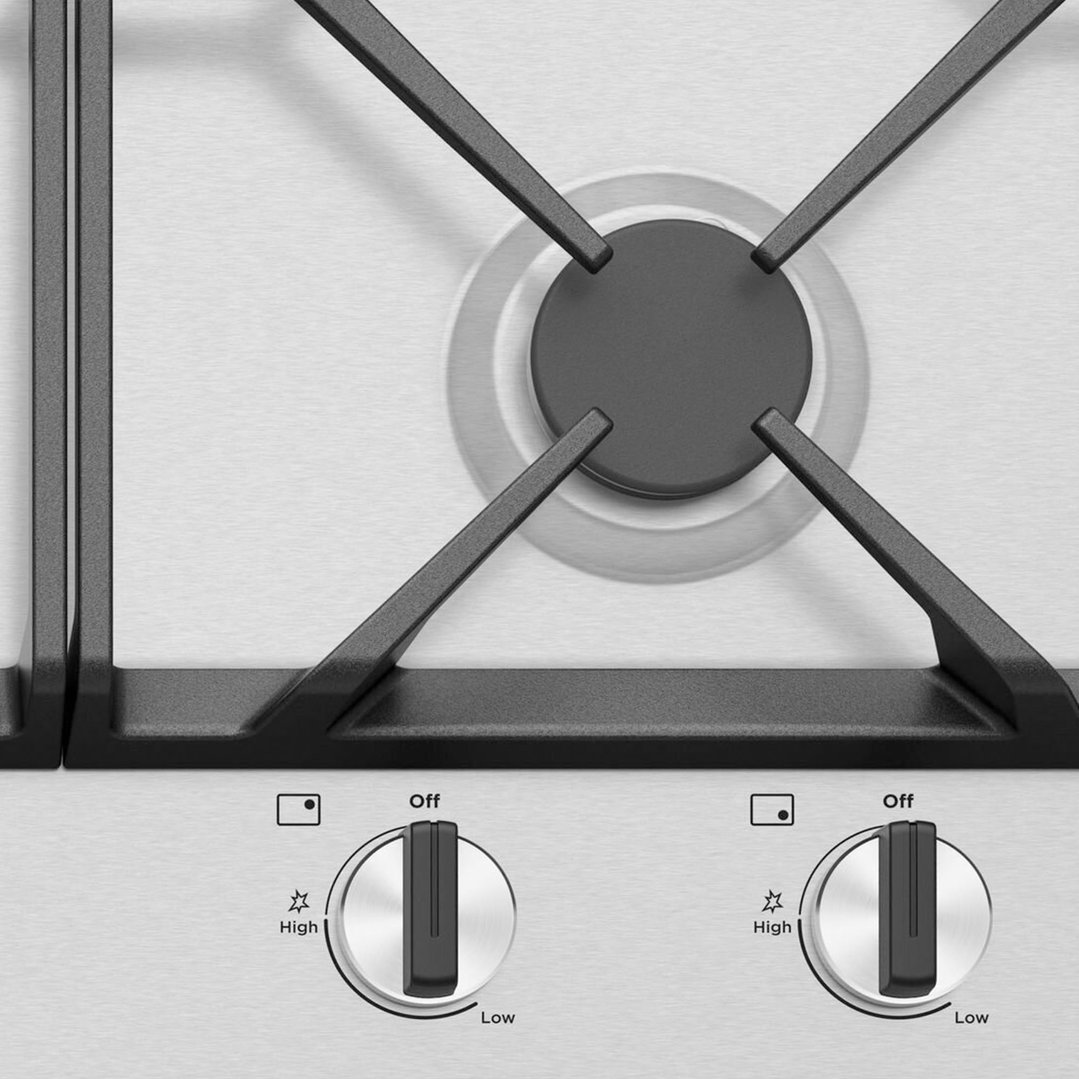 Close up of two control knobs on a gas cooktop