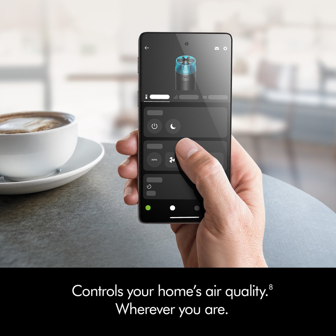 Hand holding a smartphone displaying the app for the HushJet™ Purifier Compact