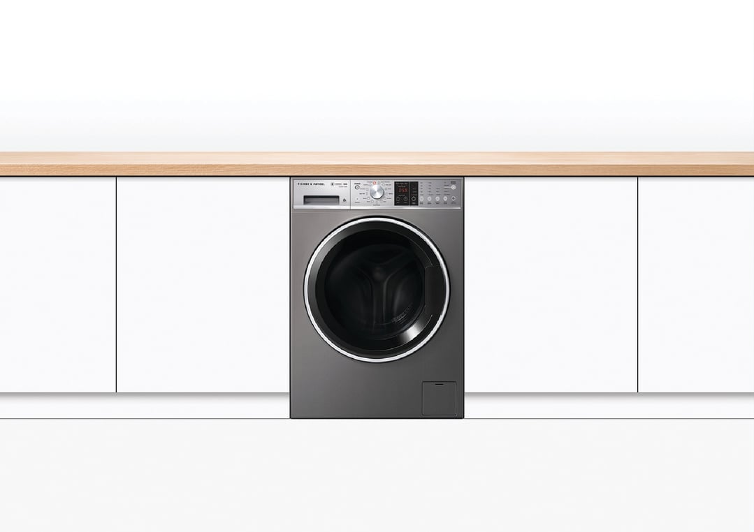 A Fisher & Paykel washing machine integrated into a white kitchen cabinet setting