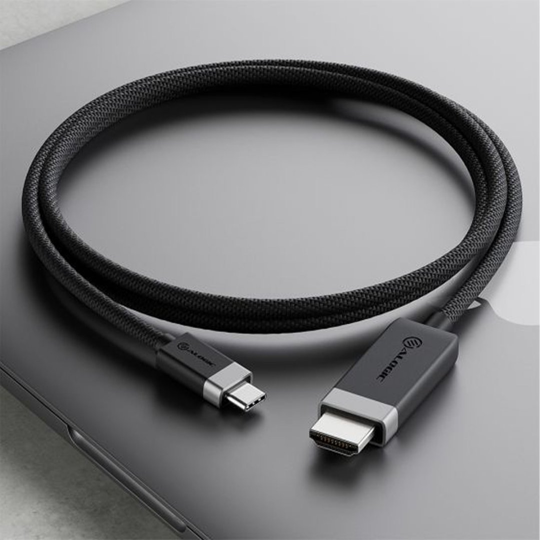 Black braided USB-C to HDMI cable on a dark grey laptop