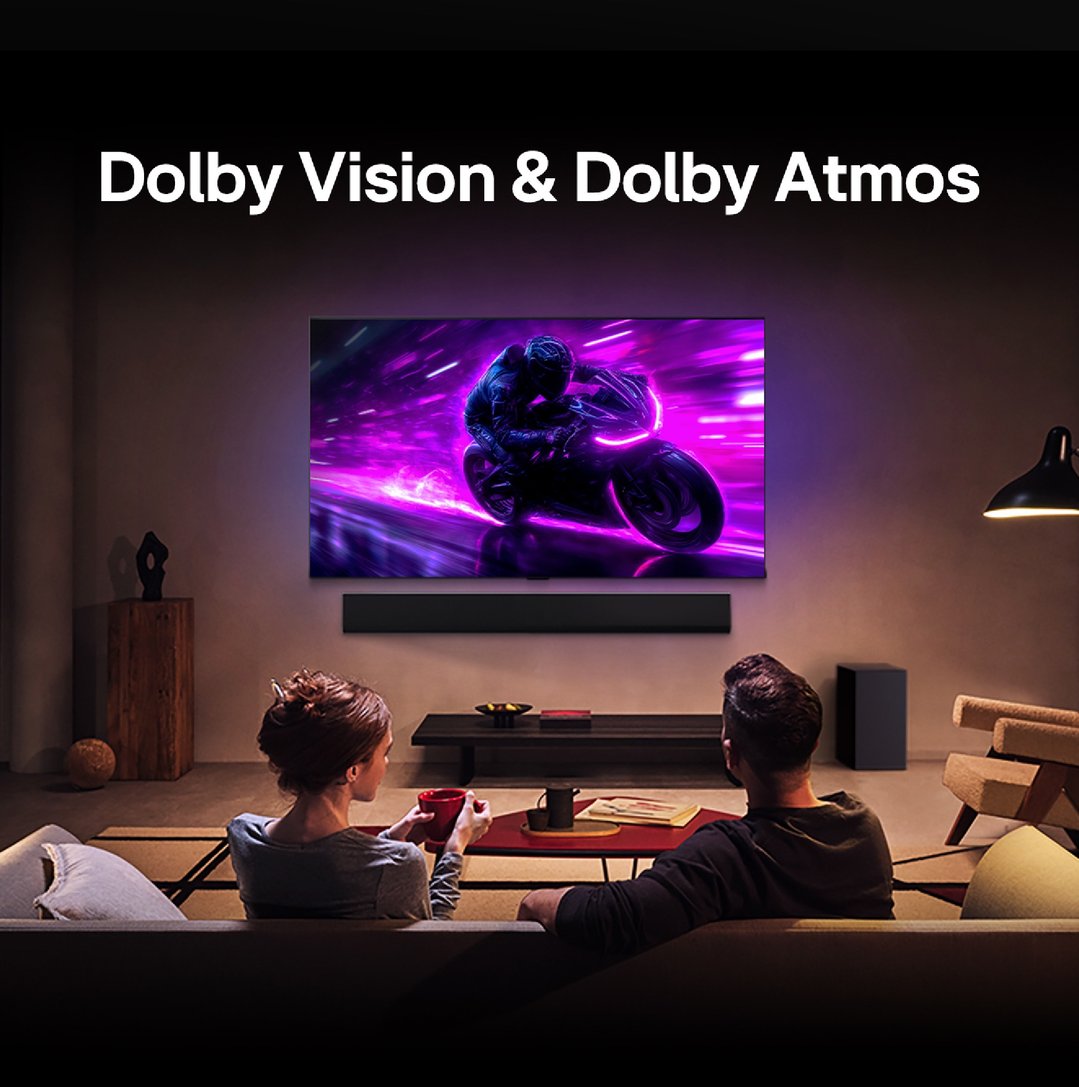 Couple watching a TV with a motorcycle scene and Dolby Vision & Atmos text