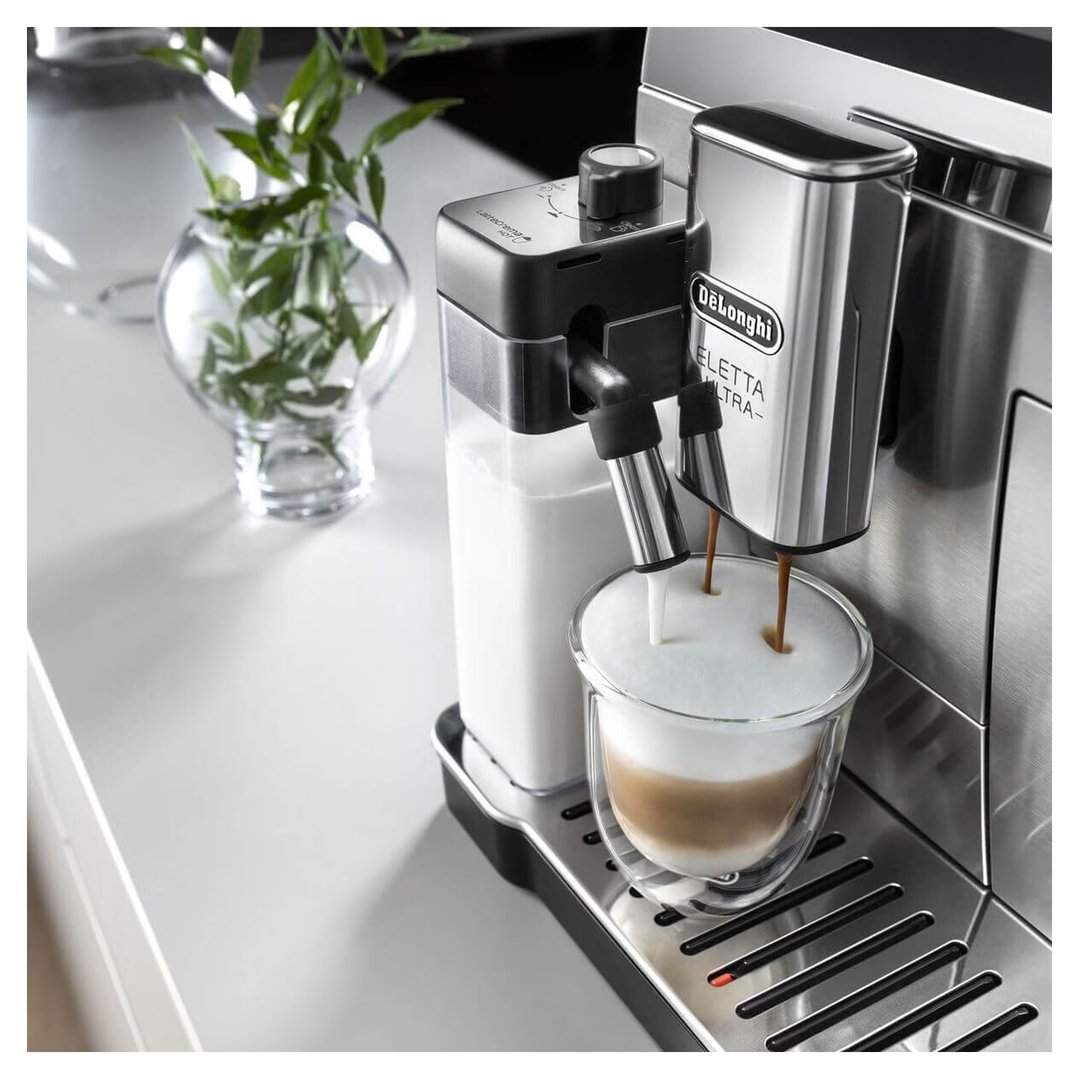 DeLonghi Eletta Ultra Fully Automatic Coffee Machine dispensing coffee and milk into a glass