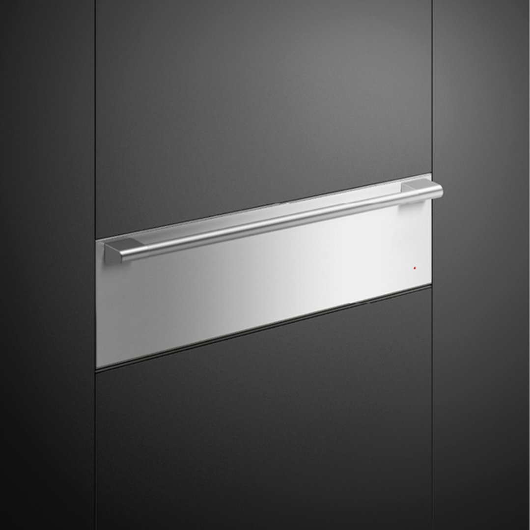 A close-up of a warming drawer with a stainless steel handle and control panel