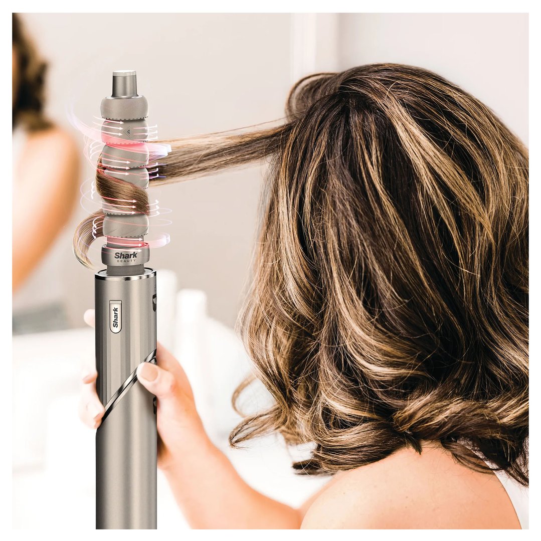 A woman styling her hair with the Shark FlexStyle Air Styling & Drying System