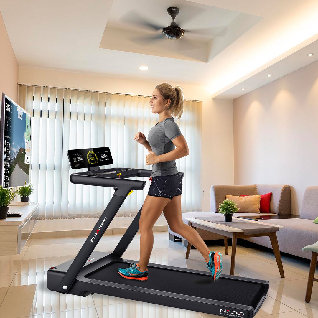 Woman running on a treadmill in a living room with a TV and couch