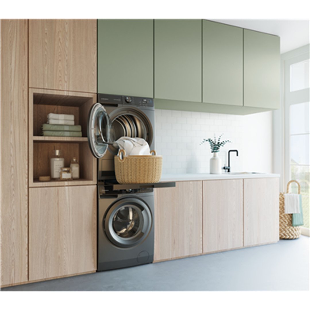 Laundry room with stacked washer and dryer, open dryer door with clothes