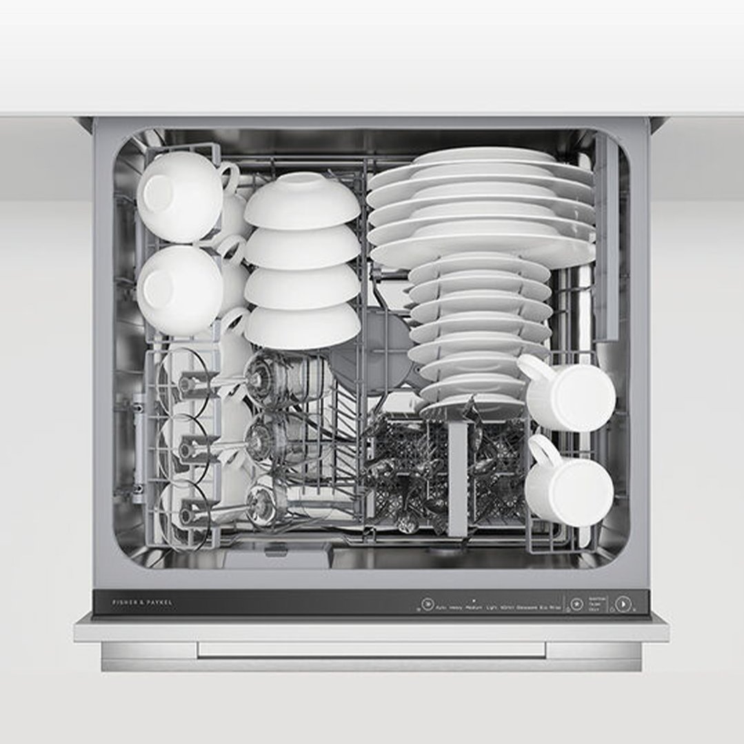 Top-down view of a fully loaded DishDrawer dishwasher with white dishes