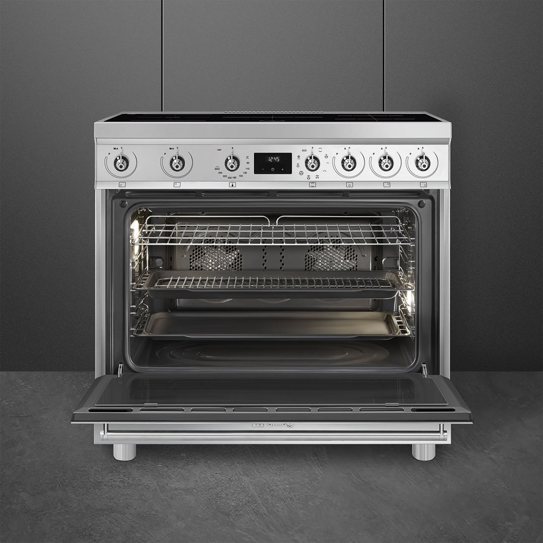 SMEG freestanding cooker with oven door open, showing interior racks and trays