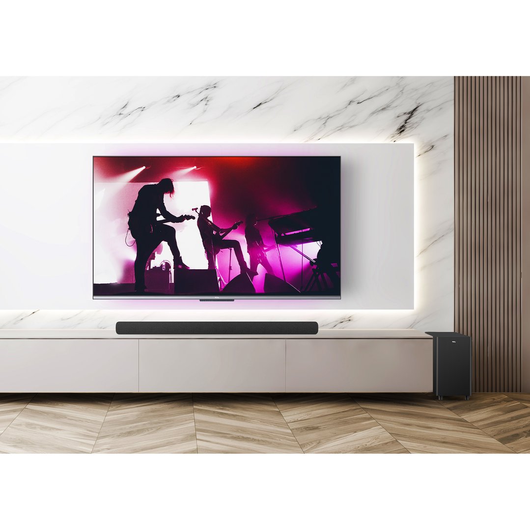 Soundbar and wireless subwoofer in a living room with a TV playing a concert