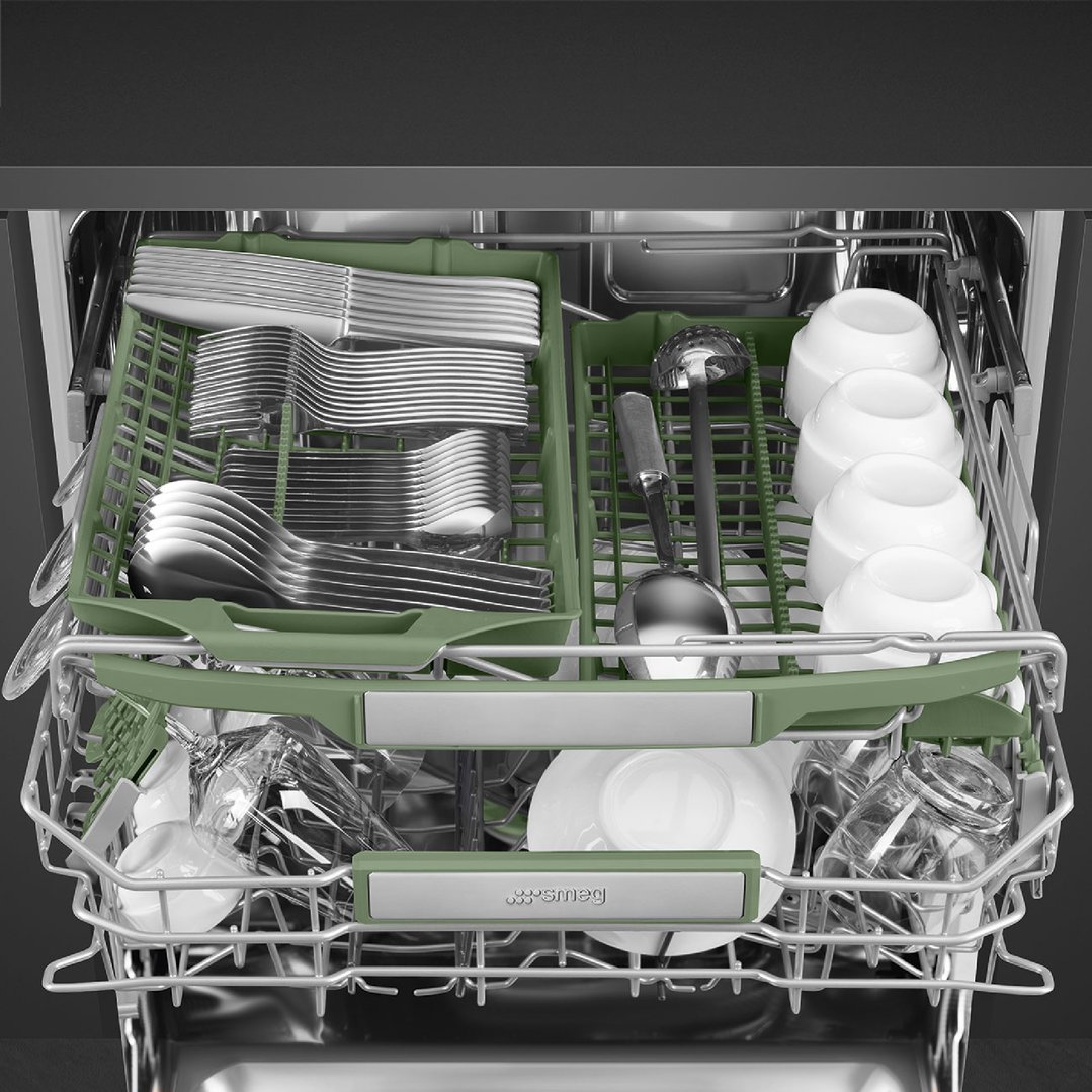 Open dishwasher with cutlery, cups, and dishes on green racks