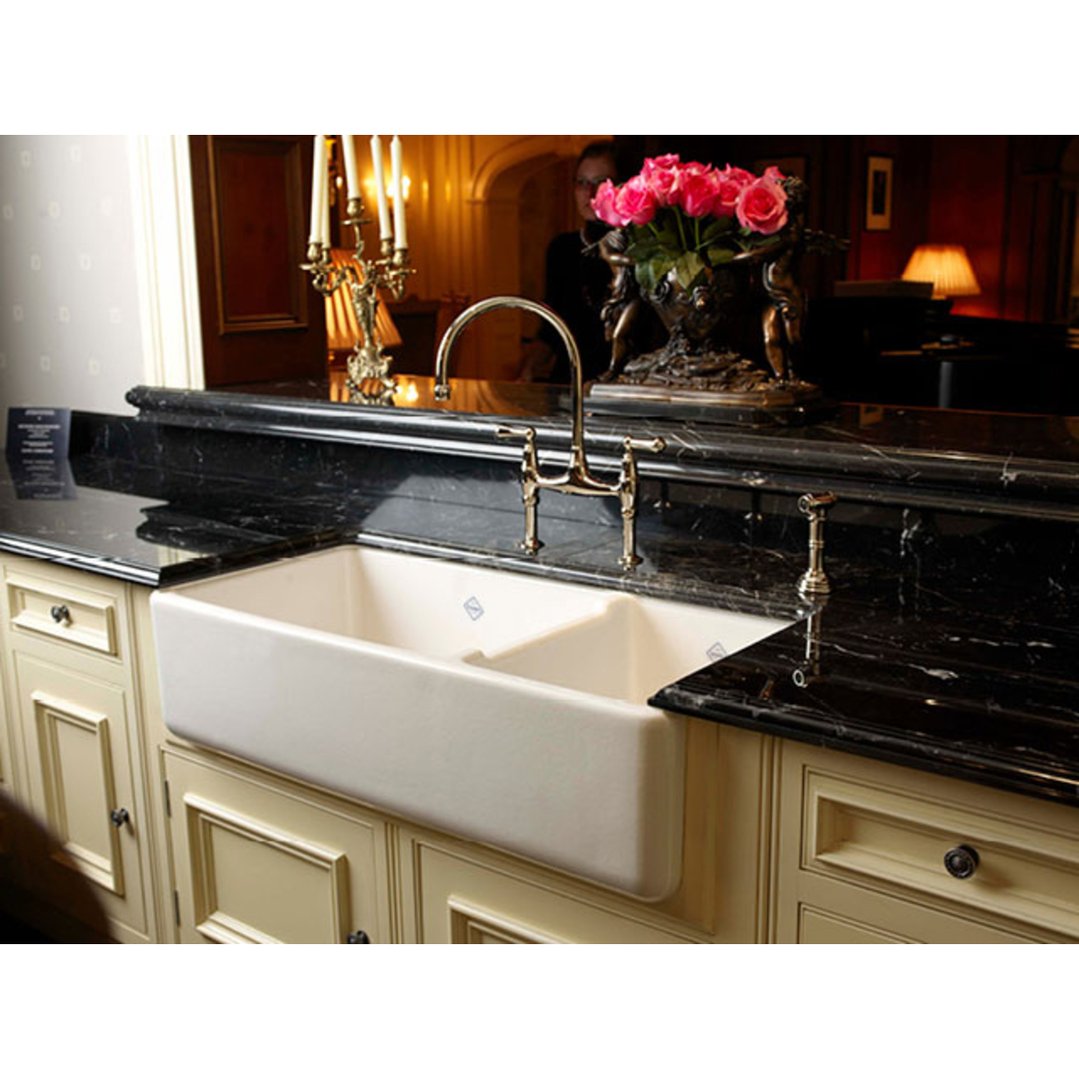 Edgeworth double bowl sink in a kitchen with black marble countertops