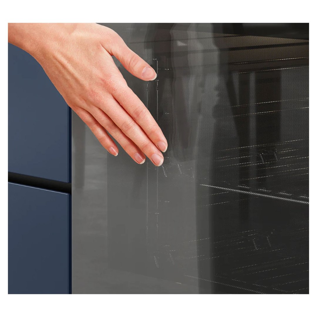 Hand touching the glass door of a Westinghouse multifunction oven