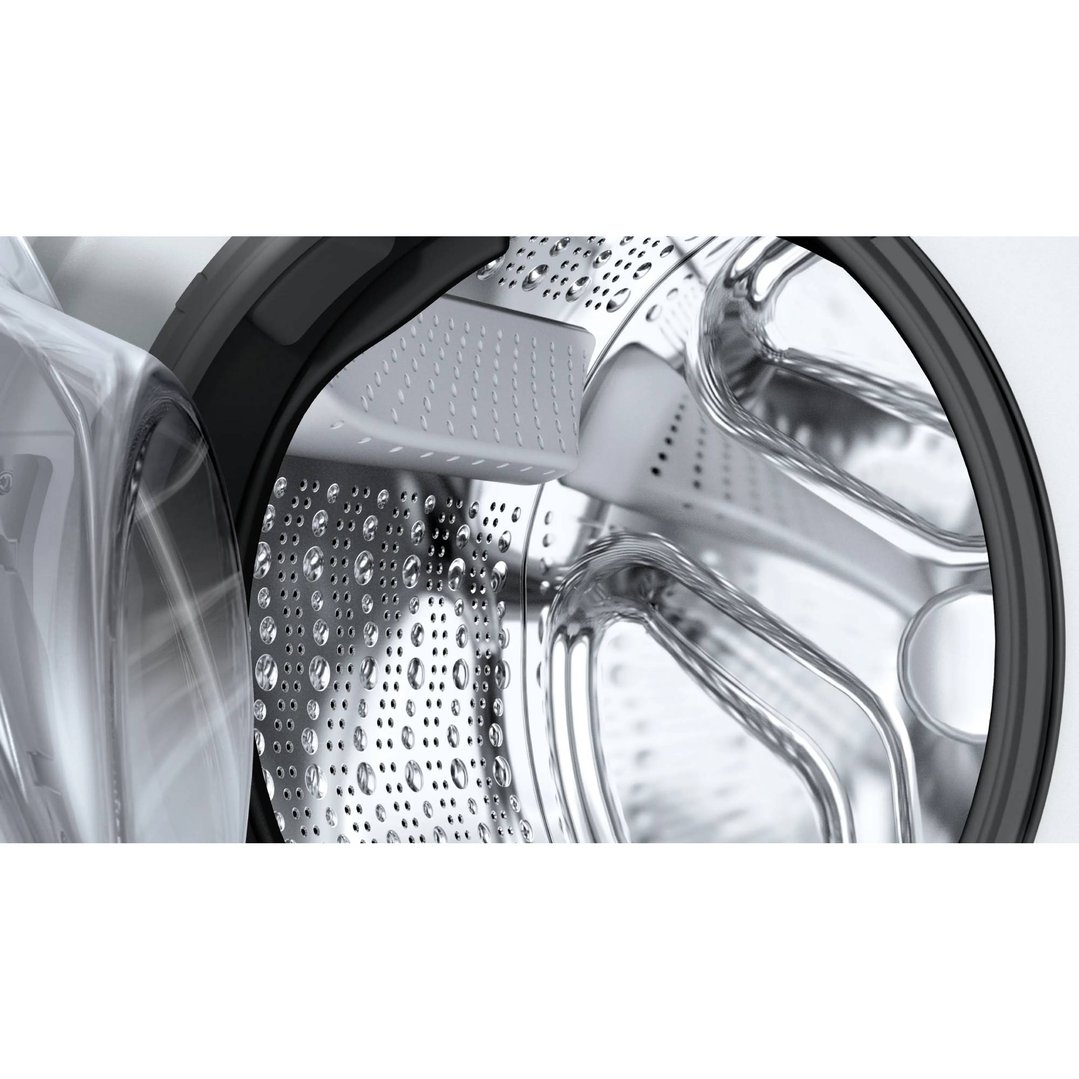 Close-up of the washing machine drum with water droplets inside