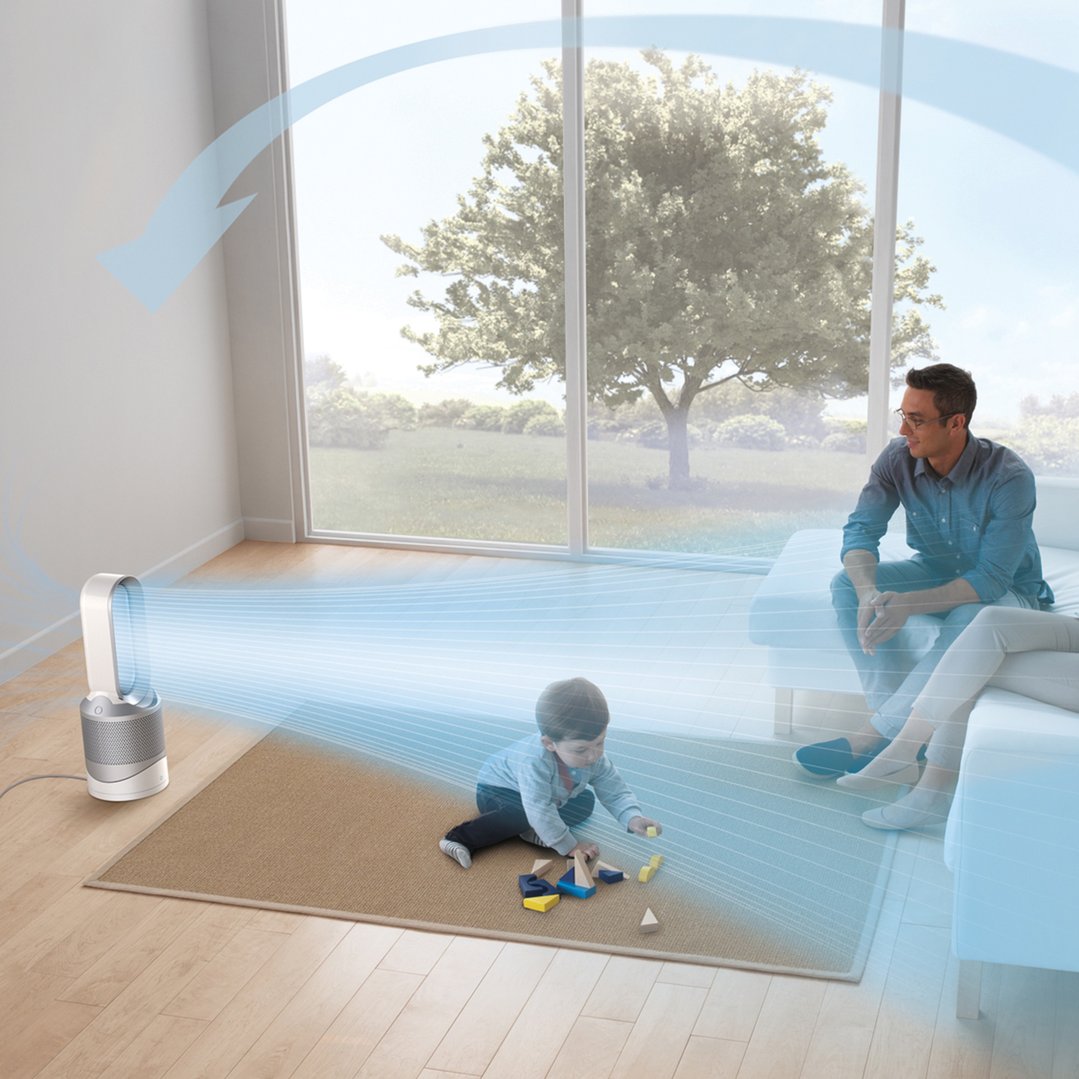 Dyson air purifier blowing air across a room with a family