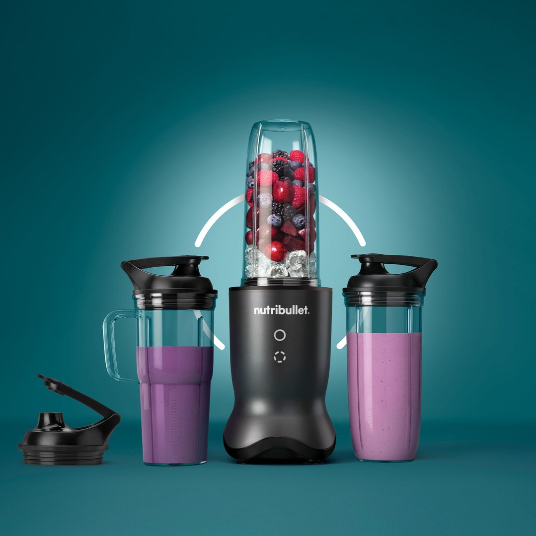 Nutribullet blender with two cups of smoothies and one cup of berries