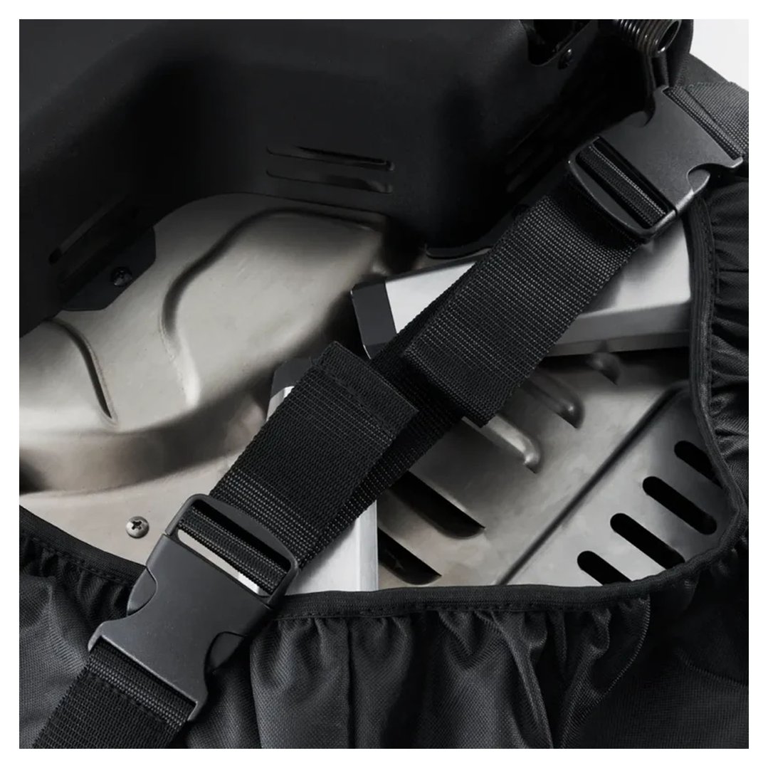 Close-up of a black transport bag with buckles and a pizza oven inside
