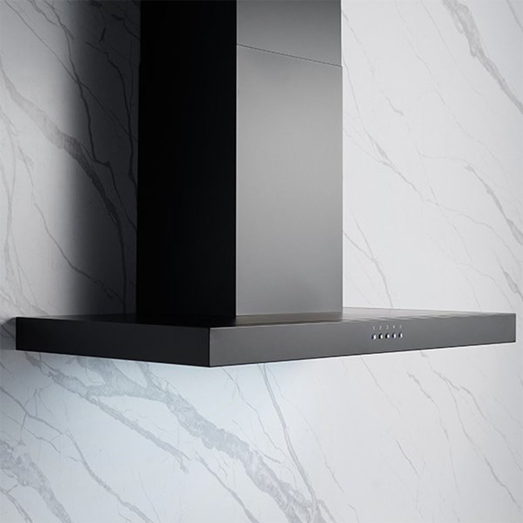 Black canopy rangehood mounted on a white marble-patterned wall