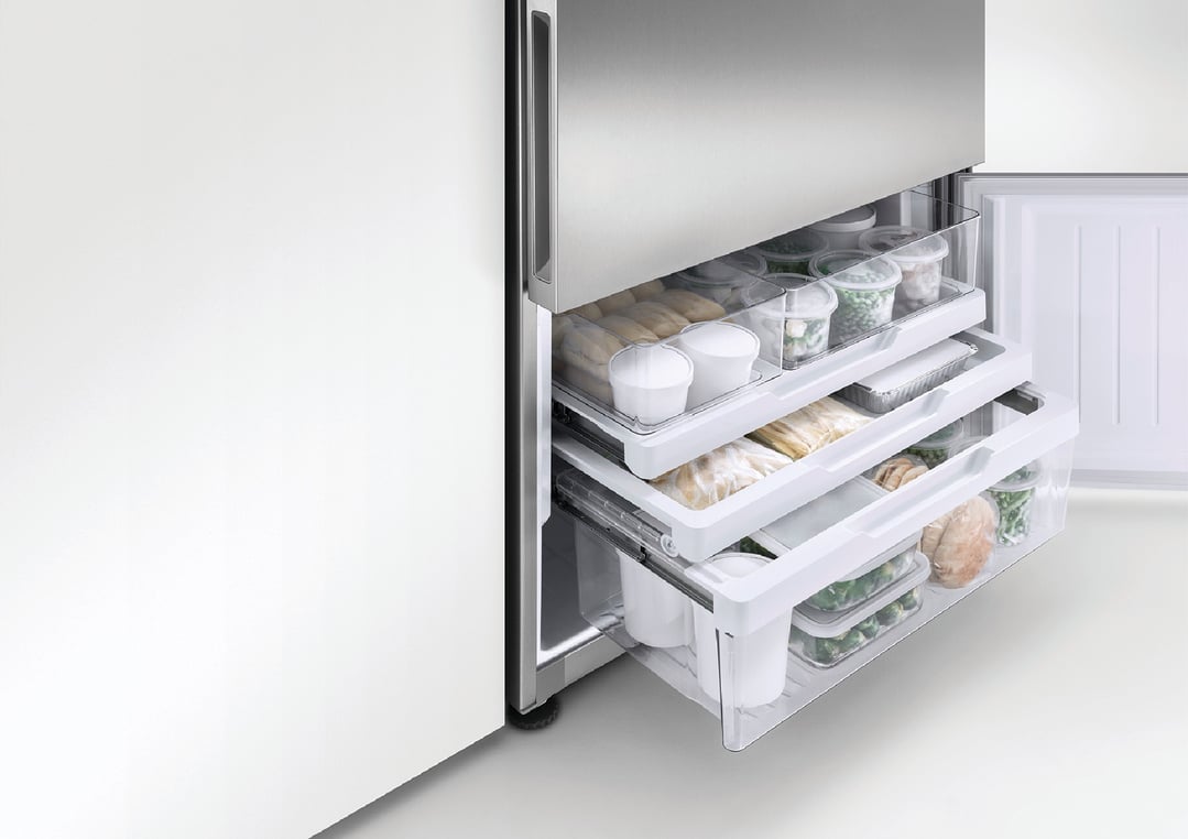 Open freezer drawers of a Refrigerator Freezer filled with food containers
