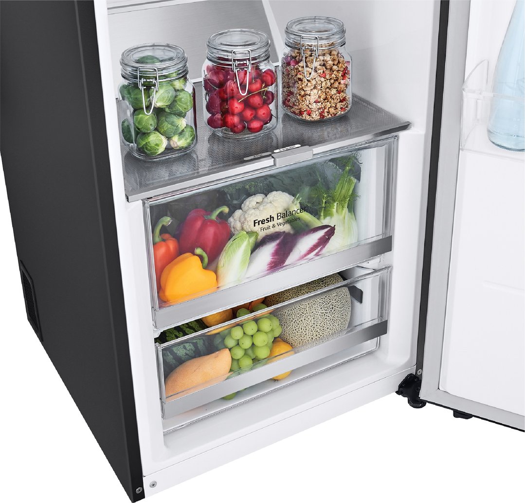 Open LG fridge interior with fresh produce in crisper drawers and jars