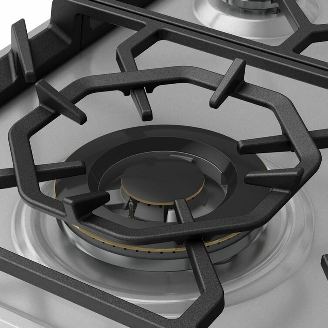 Close up of a gas cooktop burner and grates on a stainless steel surface