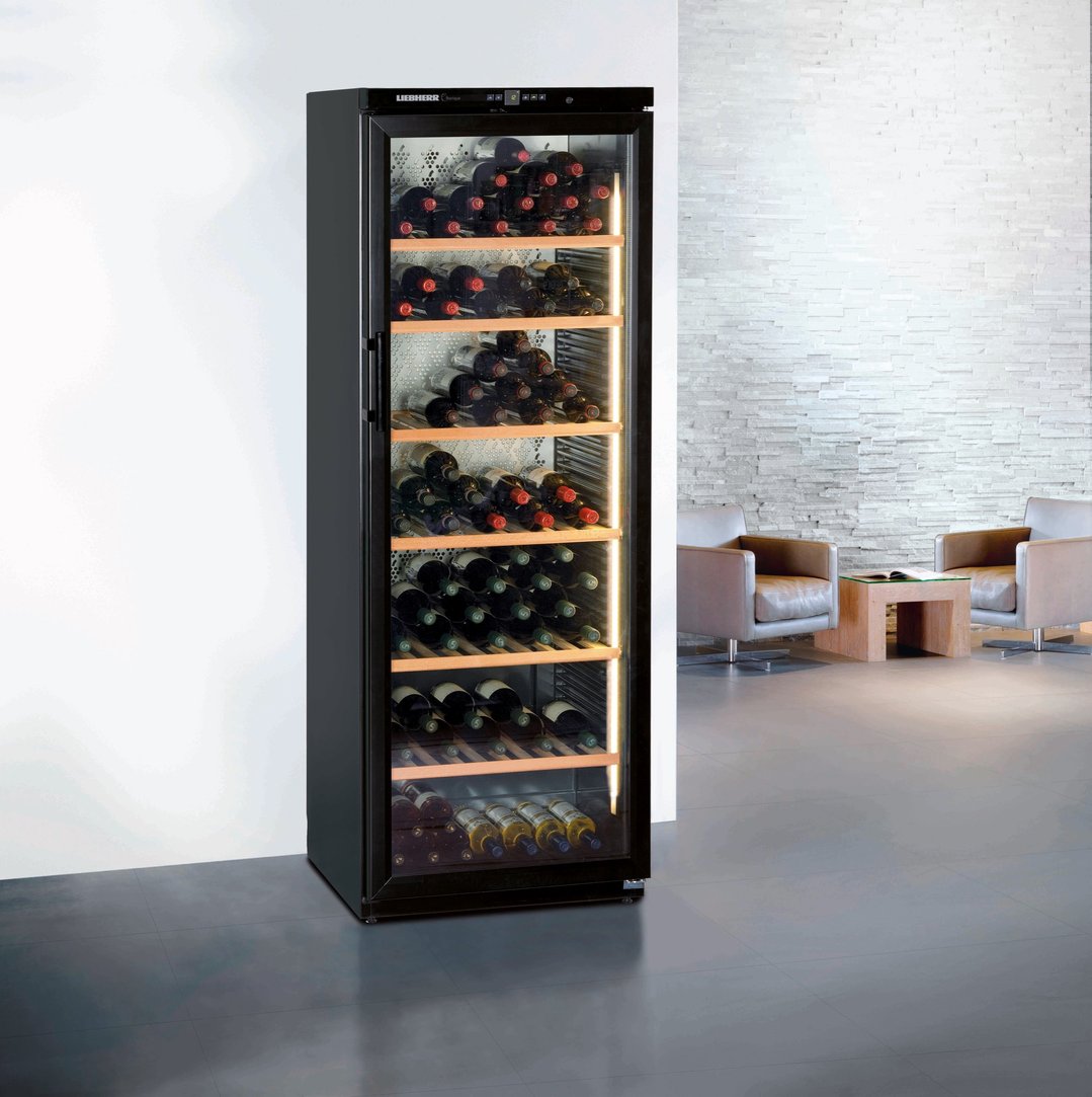 Liebherr wine cabinet in a modern room with two armchairs and a coffee table