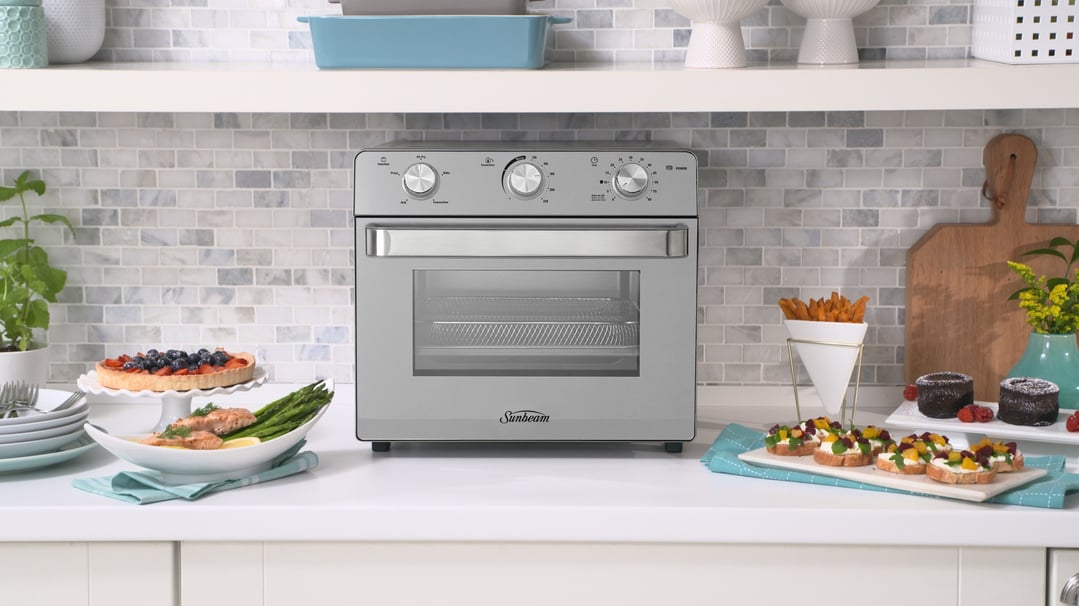 Sunbeam Multi Function Oven + Air Fryer on a kitchen counter with food