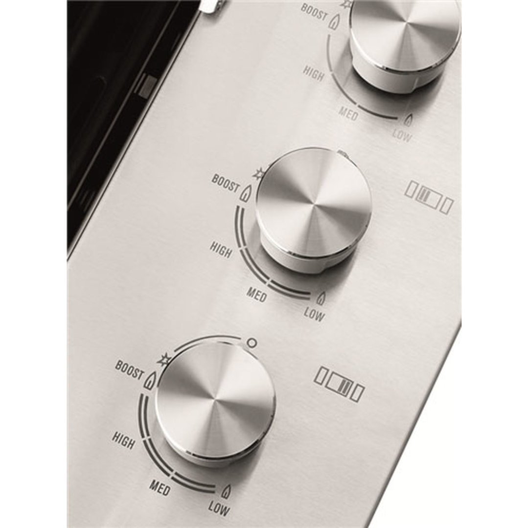 Close up of three control knobs on a stainless steel built-in BBQ