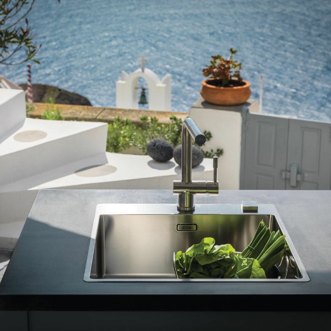 Franke Bolero single bowl sink with vegetables in an outdoor kitchen overlooking the sea