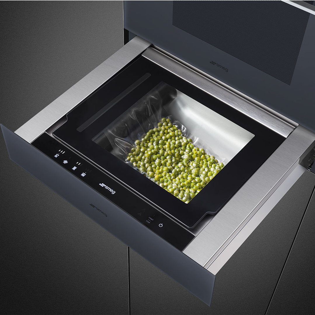 Vacuum drawer with a bag of green peas inside, ready for sealing