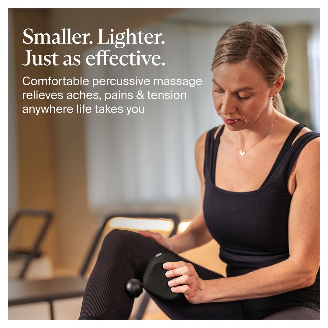 Woman using a black Theragun Mini massager on her thigh