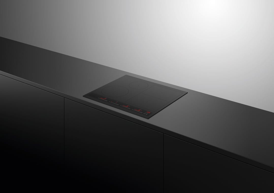 Black induction cooktop built into a dark kitchen counter