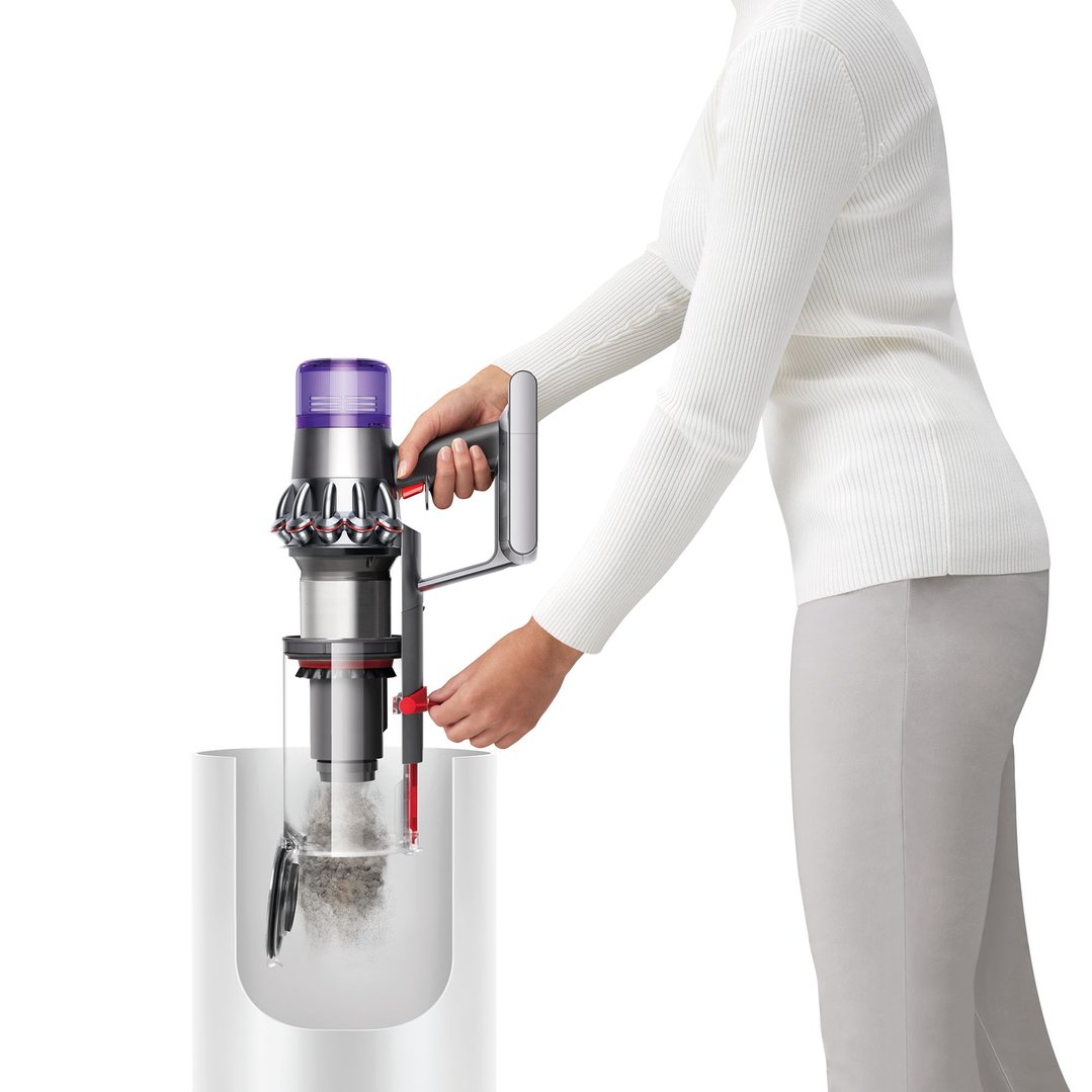 Woman emptying the Dyson V11™ Stick Vacuum into a bin