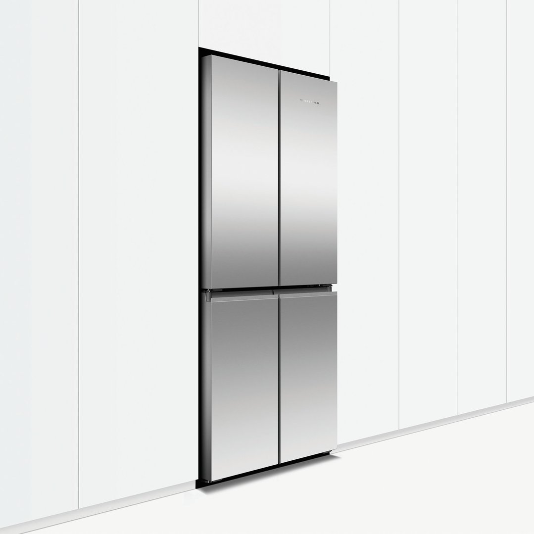 Stainless steel quad door refrigerator freezer built into white kitchen cabinetry