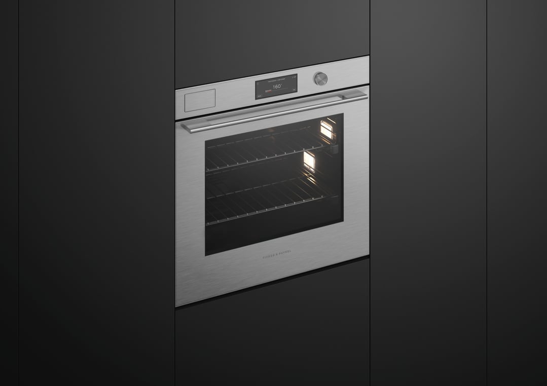 Built-in Fisher & Paykel oven with a digital display in a dark kitchen