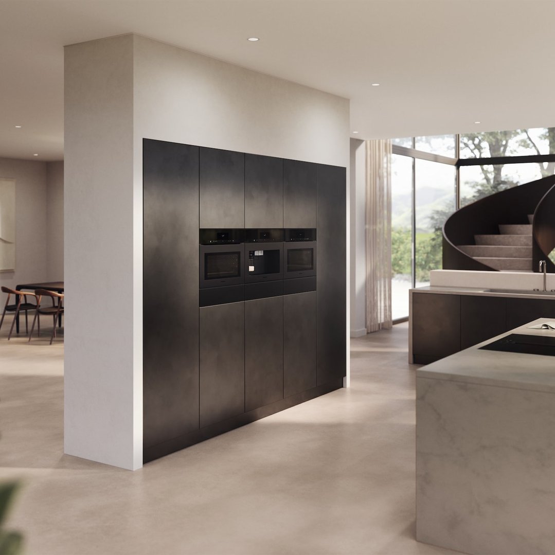 Three built-in ovens and a warming drawer in a modern kitchen setting