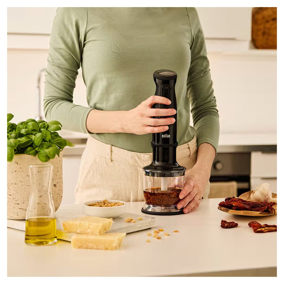 Person using a Braun MultiQuick 3 Hand blender to prepare pesto