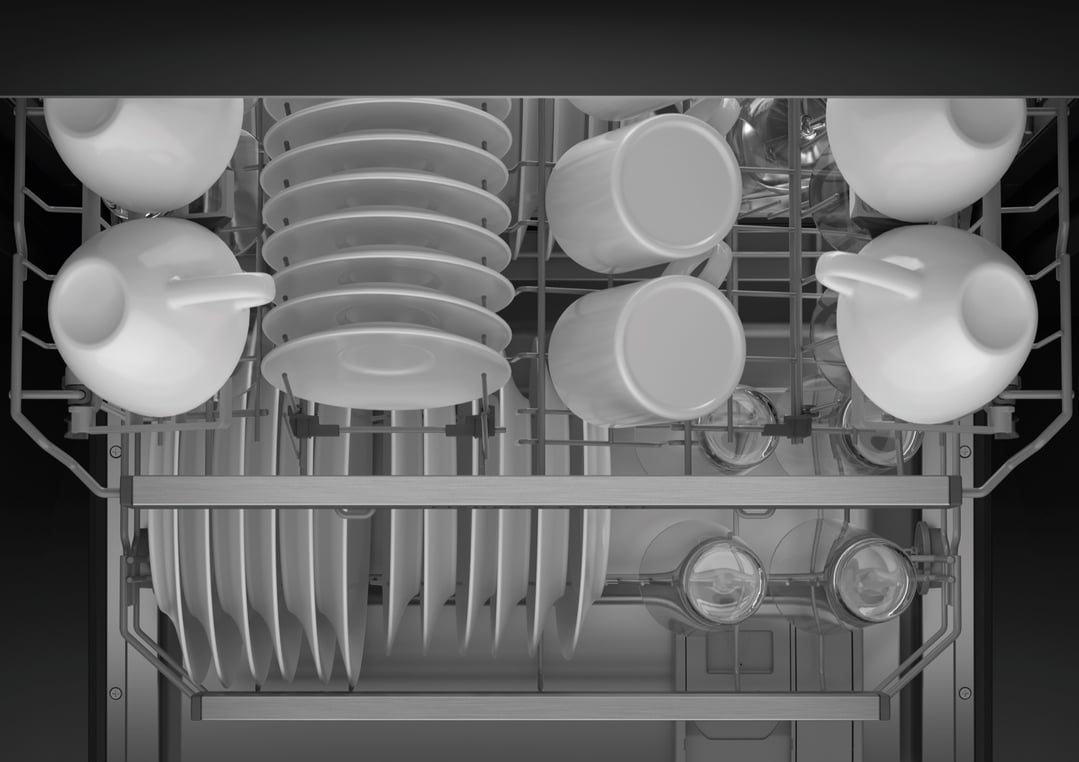 Top-down view of a fully loaded dishwasher with white dishes and cups