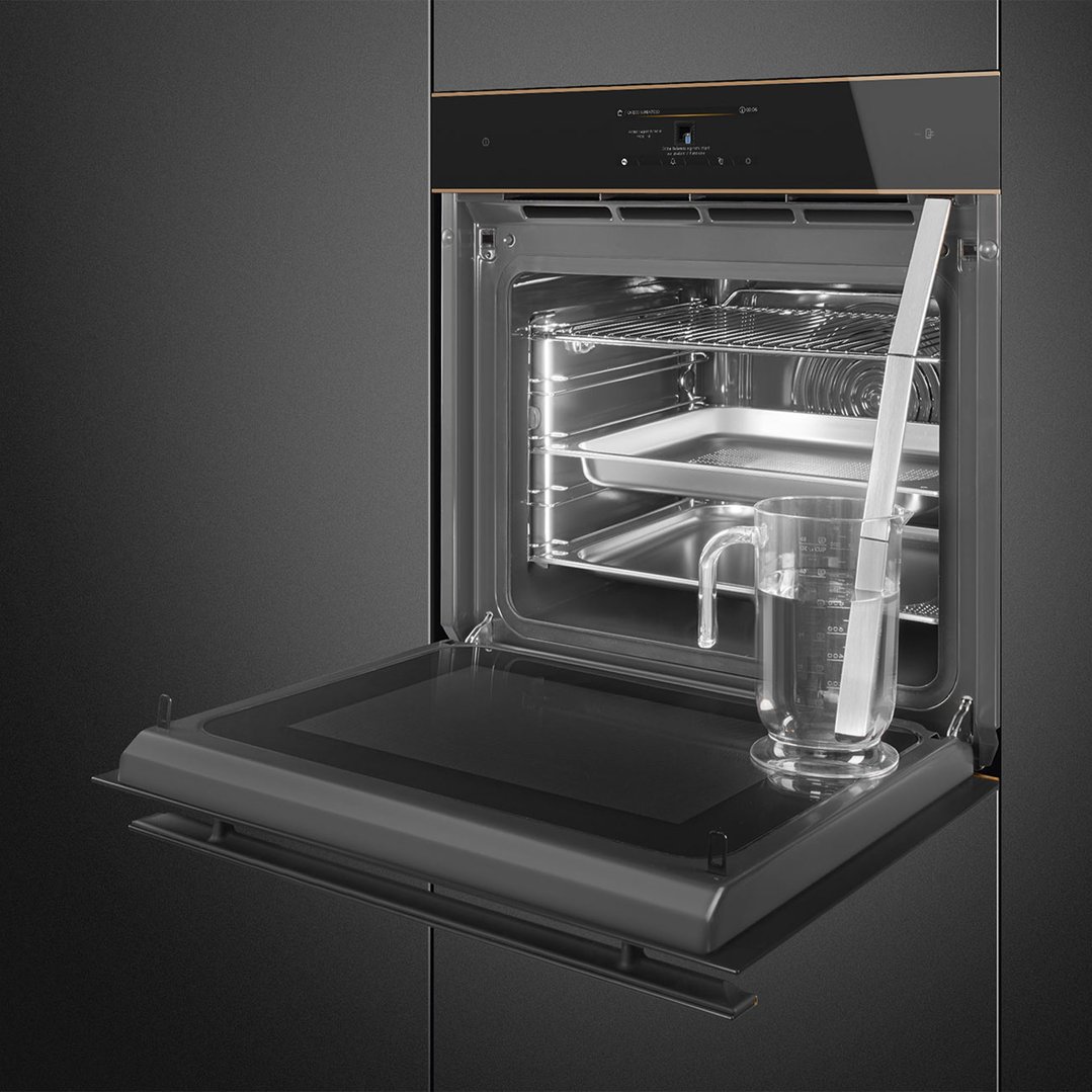 An open Dolce Stil Novo OmniChef oven with a measuring cup inside