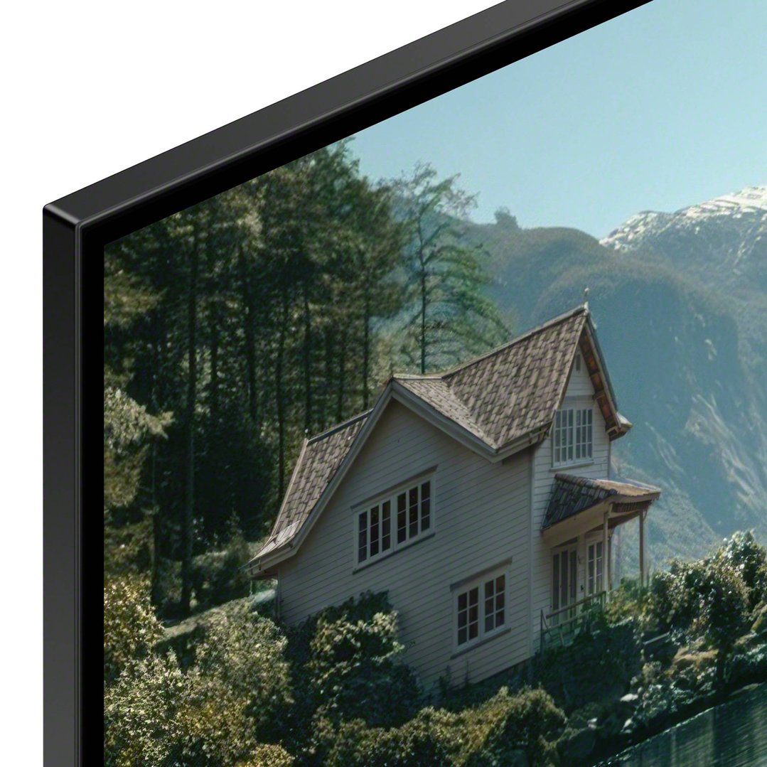 A close-up of a SONY TV displaying a house in a mountainous landscape