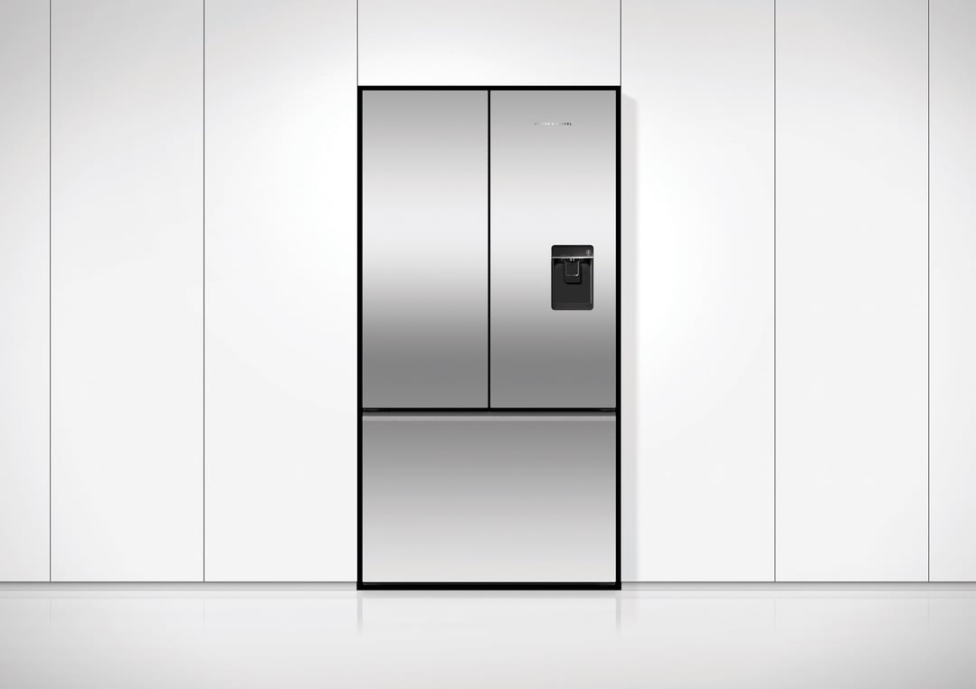 Stainless steel French door refrigerator freezer with ice and water dispenser in a kitchen