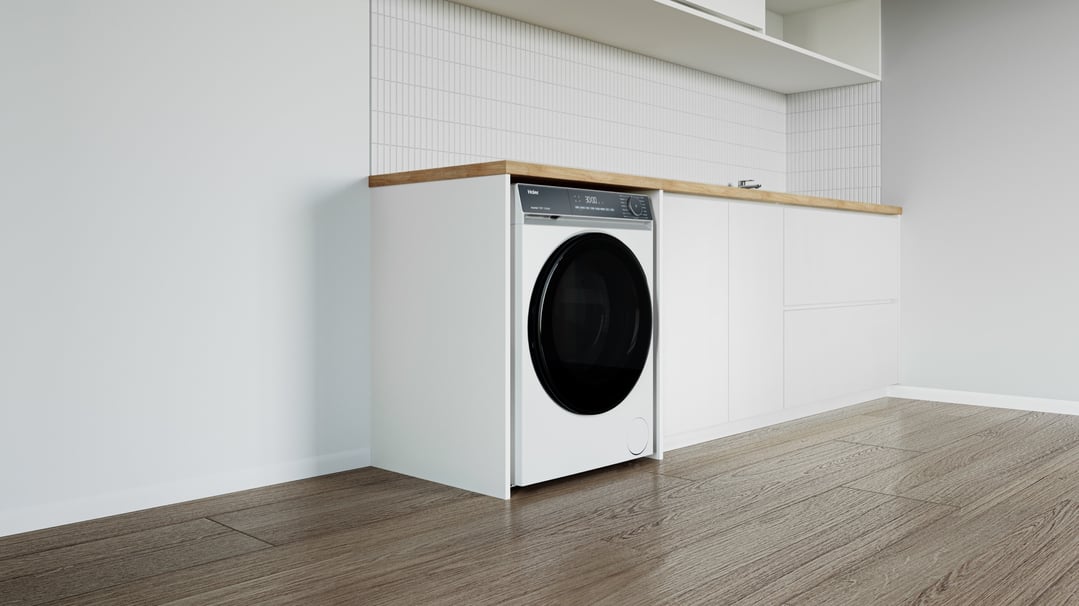 White front load washing machine built into a modern kitchen or laundry setting