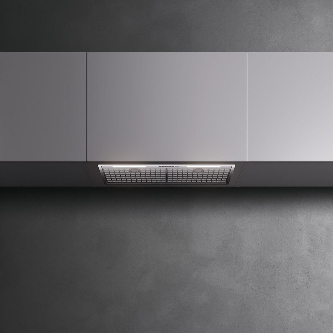 Built-in rangehood with illuminated grilles under grey kitchen cabinets
